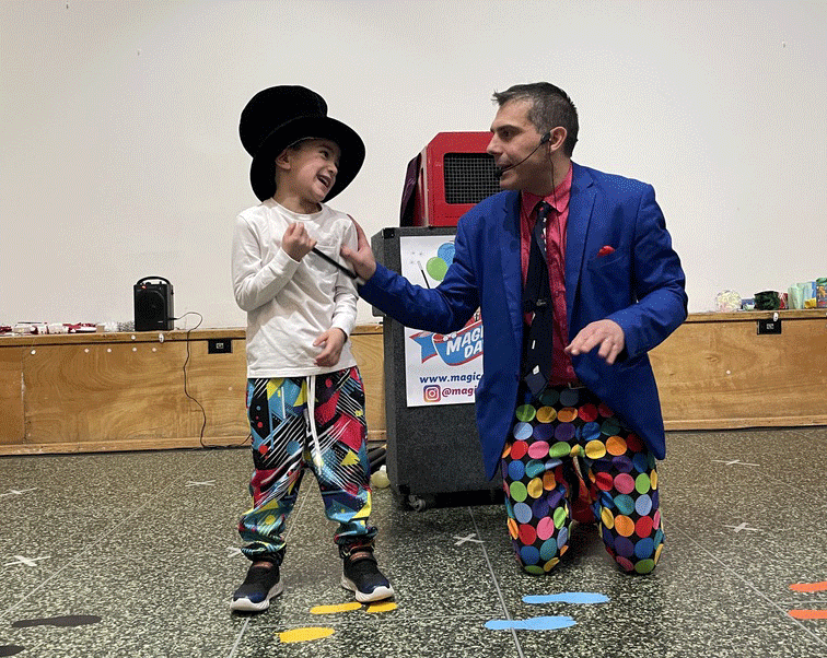 magical-dave-nyc-magic-shows-kids1 Magical Dave laughing with a young volunteer during a trick at a birthday party